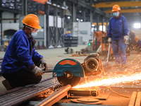 A worker is performing cutting operations at the production workshop of Nanjing Changjiang Industrial Furnace Technology Group Co., Ltd. in...