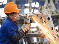 A worker is grinding at the production workshop of Nanjing Changjiang Industrial Furnace Technology Group Co., Ltd. in Nanjing, Jiangsu Prov...