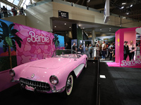 People are taking photos of a Barbie-themed convertible at the Canadian International Auto Show in Toronto, Canada, on February 19, 2024. (