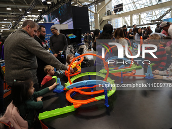 Children are playing with Hot Wheels cars at the Canadian International Auto Show in Toronto, Canada, on February 19, 2024. (