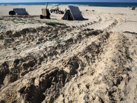 Displaced Palestinians are checking their belongings in the tiny coastal area of Al-Mawasi after Israeli tanks reportedly raided the sector,...
