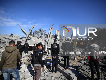 Palestinians are inspecting the damage caused by Israeli bombardment in Al-Zawayda, central Gaza Strip, on February 22, 2024, while battles...