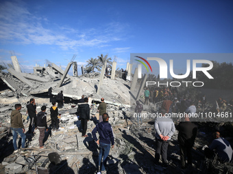 Palestinians are inspecting the damage caused by Israeli bombardment in Al-Zawayda, central Gaza Strip, on February 22, 2024, while battles...