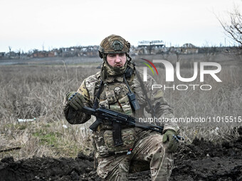 A serviceman from the 65th Separate Mechanized Brigade of the Land Forces of the Armed Forces of Ukraine is standing on the outskirts of Rob...