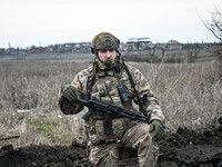A serviceman from the 65th Separate Mechanized Brigade of the Land Forces of the Armed Forces of Ukraine is standing on the outskirts of Rob...