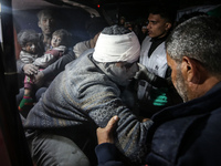 (EDITOR'S NOTE: Graphic content) Palestinians are carrying injured victims to the hospital following an Israeli airstrike on a residential b...