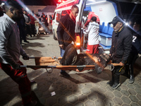 (EDITOR'S NOTE: Graphic content) Palestinians are carrying injured victims to the hospital following an Israeli airstrike on a residential b...
