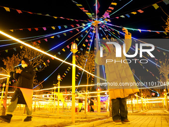 Tourists are taking selfies at the Yellow River 9 lamp array at Shandi village in Handan, North China's Hebei province, on February 22, 2024...