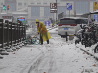 Workers are clearing snow at the Grand Tang Dynasty Everbright City scenic spot in Xi'an, Shaanxi Province, China, on February 23, 2024. (