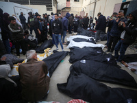 Palestinians are mourning over the bodies of those killed in an Israeli bombardment in Deir Balah in the central Gaza Strip, at the Shuhada...