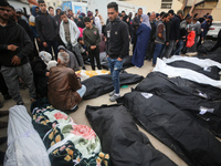 Palestinians are mourning over the bodies of those killed in an Israeli bombardment in Deir Balah in the central Gaza Strip, at the Shuhada...