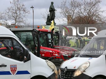 This photograph, taken in Paris, France, on February 23, 2024, shows tractors parked by French farmers who are participating in a demonstrat...