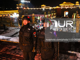 Police officers are on duty at the Tanguo Ancient City scenic spot in Linyi, China, on February 23, 2024. (