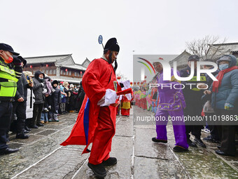 Folk artists are performing traditional folk customs at the Ancient City scenic spot in Qingzhou, Shandong Province, China, on February 24,...