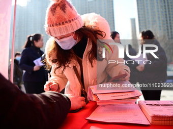 A job seeker is signing an employment agreement with an employer at a spring job fair for small and medium-sized enterprises in Liaocheng, C...