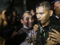 A man is reacting during rescue operations following a fire in a commercial building that has killed at least 43 people in Dhaka, Bangladesh...