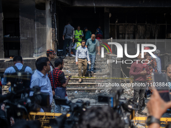 Firefighters and forensic experts are inspecting a commercial building in Dhaka, Bangladesh, on March 1, 2024, the day after a fire claimed...