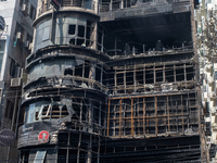 Firefighters and forensic experts are inspecting a commercial building in Dhaka, Bangladesh, on March 1, 2024, the day after a fire claimed...