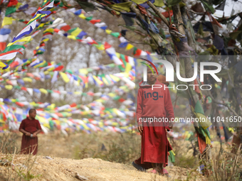 Nepali novice Buddhist monks are playing in a monastery area on the outskirts of Kathmandu, Nepal, on March 2, 2024. (