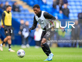 Sullay Kaikai #14 of Cambridge United is warming up before the match during the Sky Bet League 1 match between Bolton Wanderers and Cambridg...