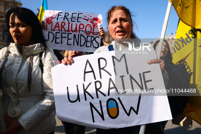 'Arm Ukrain Now' banner is seen during a daily demonstration of solidarity with Ukraine at the Main Square in Krakow, Poland on March 3rd, 2...