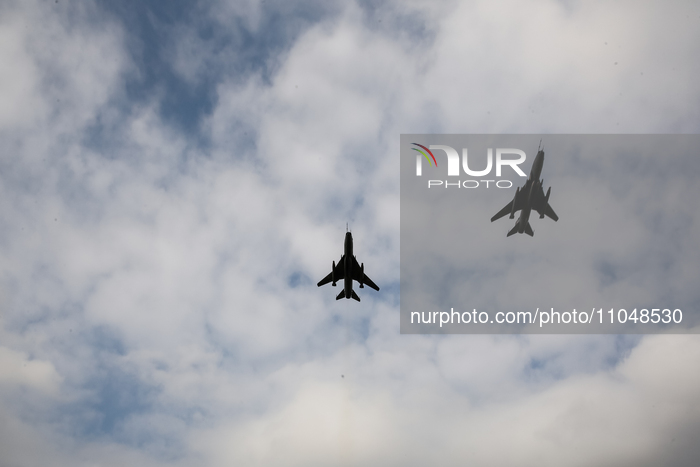 SU22 fly as servicemen exercise ability to cross armored vehicles through Vistula river on ferries during NATO's  Dragon-24 exercise, a part...