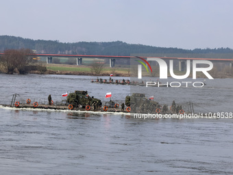 Poland flagged vehicle rides as servicemen exercise ability to cross Rosomak armored vehicles through Vistula river on ferries during NATO's...