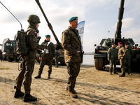 Servicemen present armed vehicles during NATO's  Dragon-24 exercise, a part of large scale Steadfast Defender-24 exercise in Korzeniewo, Pol...