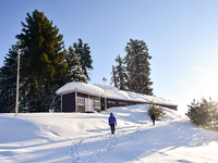 People are walking through the snow on a sunny winter morning at the Gulmarg Ski Resort in Baramullah district, Indian Administered Kashmir,...