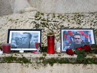 This photograph, taken in Paris, France, on March 4, 2024, shows flowers and candles being placed at the war memorial at the Parvis des Droi...