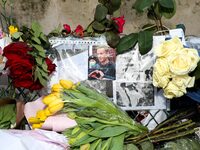 This photograph, taken in Paris, France, on March 4, 2024, shows flowers and candles being placed at the war memorial at the Parvis des Droi...