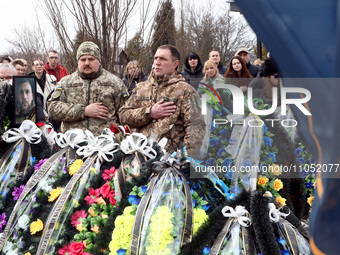 Servicemen are standing to attention during the memorial service for Ukrainian defender Daniil Semenenko, who was killed in action against R...