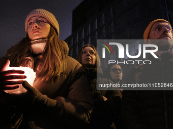 People attend a vigil for the 25 year-old refugee from Belarus named Liza who died after being attacked, raped and severely beaten in downto...