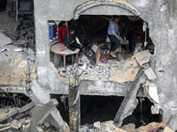 Palestinians are inspecting the damage at a home in Deir al-Balah in the central Gaza Strip on March 7, 2024, which was hit during an Israel...