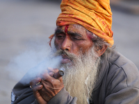 A Sadhu, or Hindu holy man, is smoking marijuana on the premises of Pashupatinath Temple in Kathmandu, Nepal, on the eve of Maha Shivaratri,...