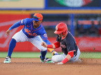 New York Mets shortstop Francisco Lindor #11 is tagging out Washington Nationals' Lane Thomas #28 during the first inning of a baseball game...