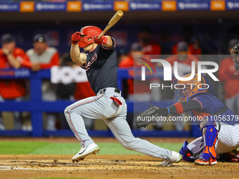 Jacob Young #30 of the Washington Nationals is driving in the first run of the game during the second inning of the baseball game against th...