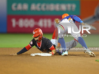 New York Mets shortstop Francisco Lindor #12 is tagging out Washington Nationals' Carter Kieboom #8 during the fourth inning of a baseball g...