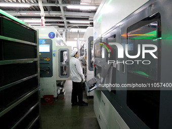 A worker is producing consumer lithium battery products at the production workshop of a new energy technology enterprise in the Dongqiao Eco...