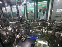 A robot is working on a production line at a new energy technology enterprise in the Dongqiao Economic and Technological Development Zone in...