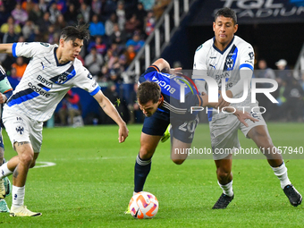 Pavel Bucha, a midfielder for Cincinnati, and Luis Romo, a defender for Monterrey, are competing for the ball during the 2024 Concacaf Champ...
