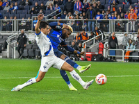 Cincinnati forward Aaron Boupendza is taking a shot on goal during the 2024 Concacaf Champions Cup Round of 16 match between FC Cincinnati a...
