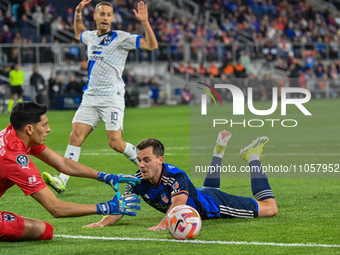 Pavel Bucha, the Cincinnati midfielder, is sliding during the 2024 Concacaf Champions Cup Round of 16 match between FC Cincinnati and CF Mon...