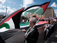 Students and feminist activists are holding Palestinian flags in support of Palestinian women at a protest against patriarchy and violence i...