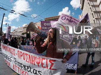 Students and feminist activists are holding a banner during a protest against patriarchy and violence in Athens, Greece, on March 8, 2024. (