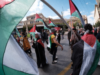 Students and feminist activists are holding Palestinian flags in support of Palestinian women during a protest against patriarchy and violen...