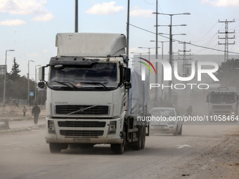 Trucks are carrying humanitarian aid into Rafah in the southern Gaza Strip after crossing the terminal border from Egypt, on March 8, 2024,...
