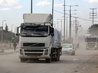 Trucks are carrying humanitarian aid into Rafah in the southern Gaza Strip after crossing the terminal border from Egypt, on March 8, 2024,...