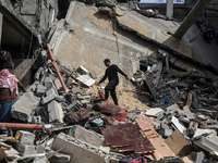 Palestinians are inspecting the damage at a home in Deir al-Balah in the central Gaza Strip on March 8, 2024, which has been hit during an I...