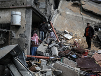 Palestinians are inspecting the damage at a home in Deir al-Balah in the central Gaza Strip on March 8, 2024, which has been hit during an I...